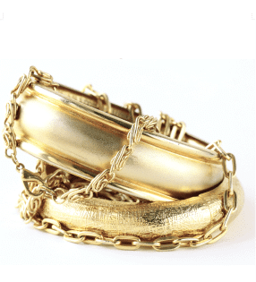 Gold bangles on a white background.