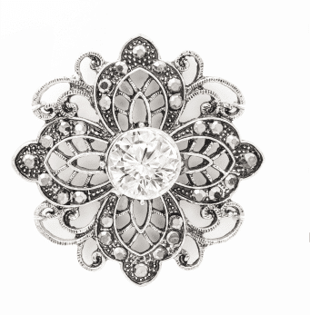 A silver and white flower brooch with a diamond in the center.