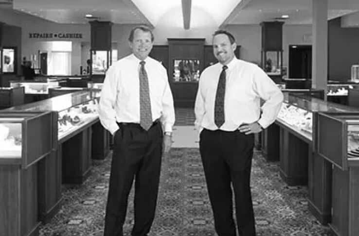 Two men standing in a jewelry store.