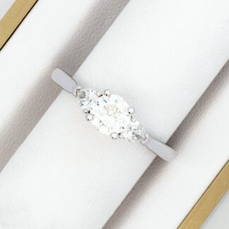 A white gold engagement ring with a diamond in the center.