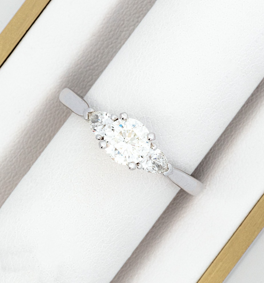 A white gold engagement ring with a diamond in the center.