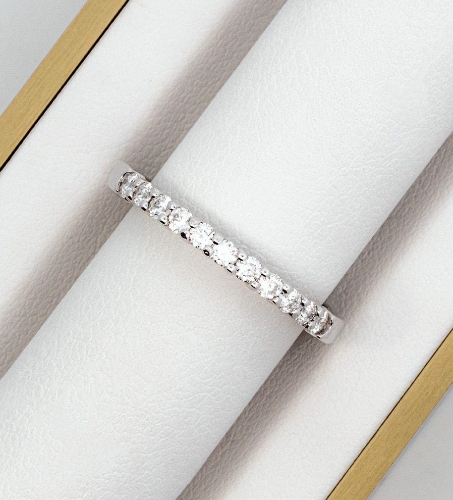 A white gold diamond eternity ring in a box.