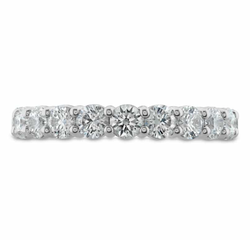 A white gold diamond band with round stones.