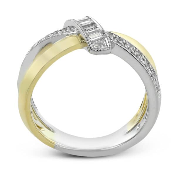 A white gold and yellow gold ring with baguette diamonds.