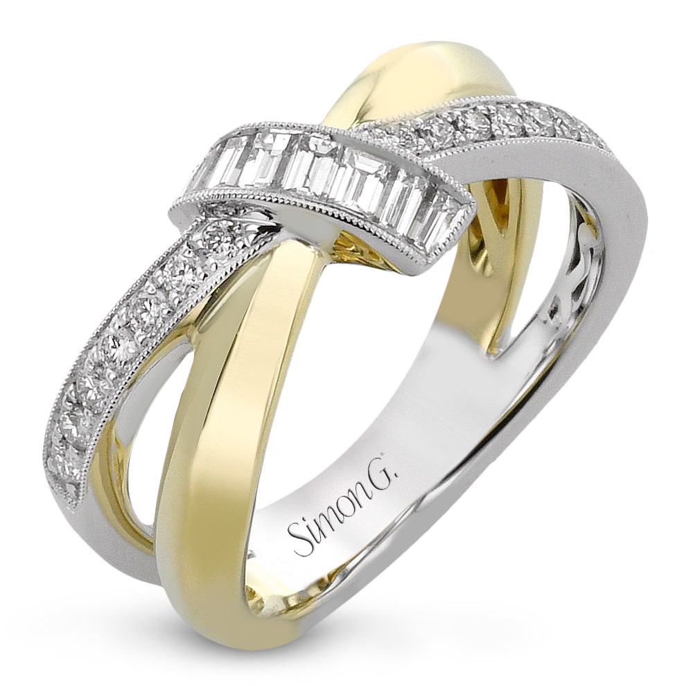 A white gold and yellow gold ring with baguette cut diamonds.