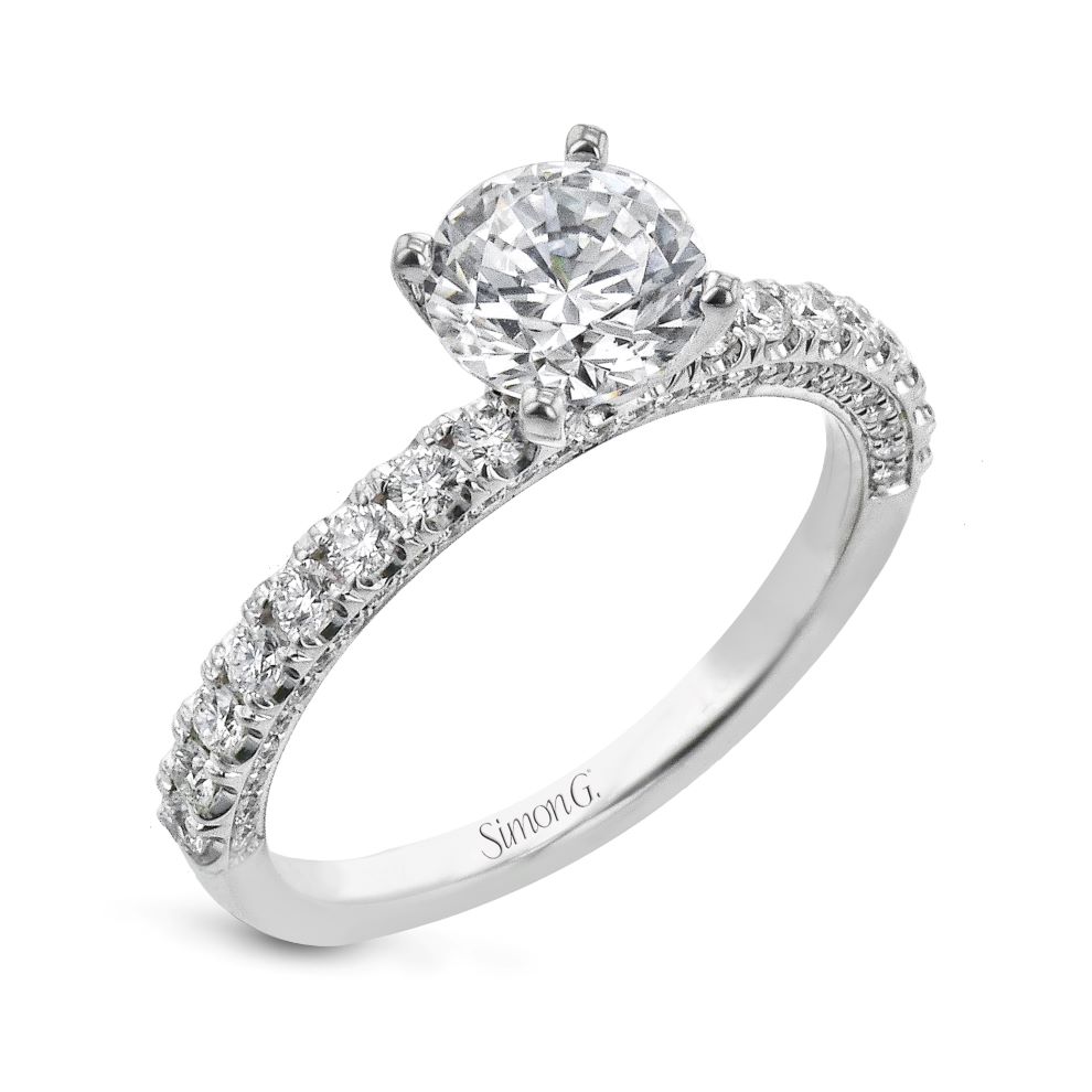 A white gold engagement ring with a round diamond.