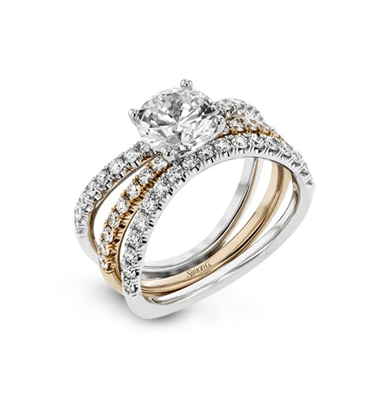 A diamond engagement ring set in two tone gold and white gold.