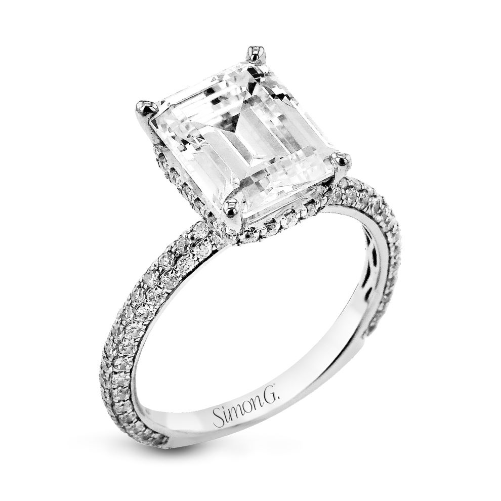 An emerald cut engagement ring with diamonds.