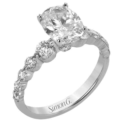 A white gold engagement ring with an oval cut diamond.
