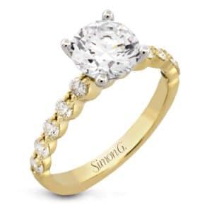 A yellow gold engagement ring with a round diamond in the center.