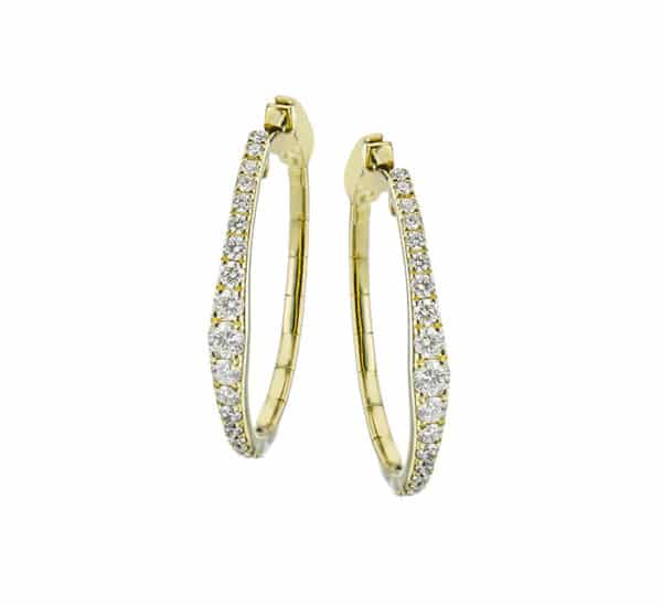 A pair of yellow gold hoop earrings with diamonds.