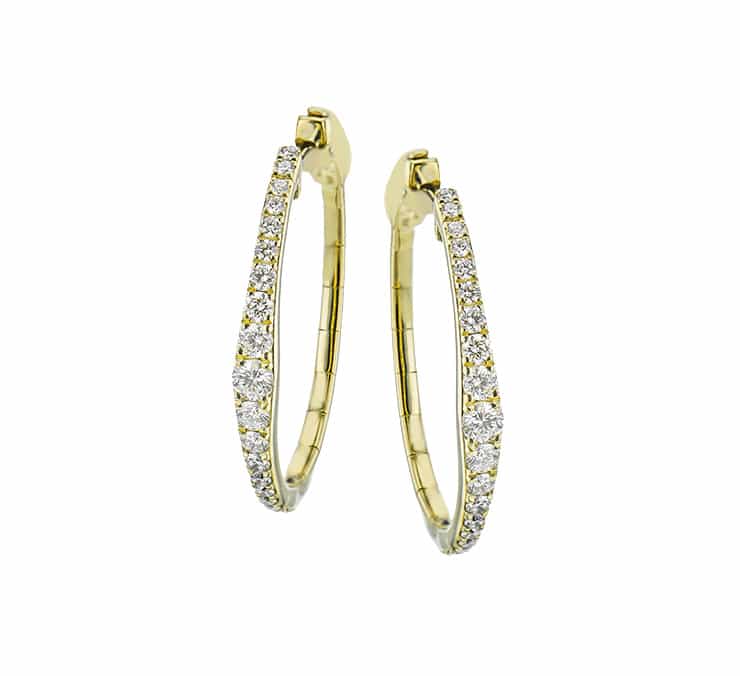 A pair of yellow gold hoop earrings with diamonds.