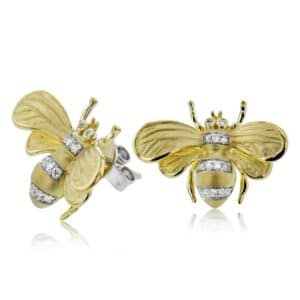 A pair of yellow gold bee stud earrings with diamonds.