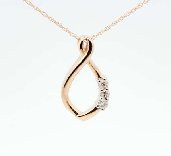 An infinity pendant with diamonds on a gold chain.