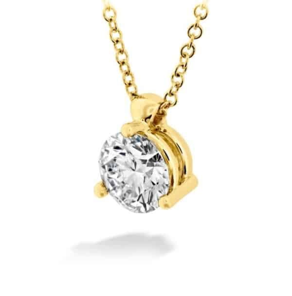 A yellow gold pendant with a round brilliant cut diamond.