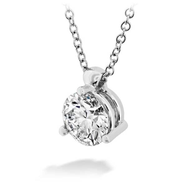 A round brilliant cut diamond pendant on a chain.