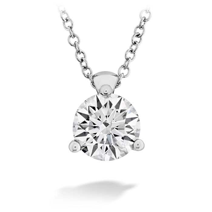A round brilliant cut diamond pendant on a chain.