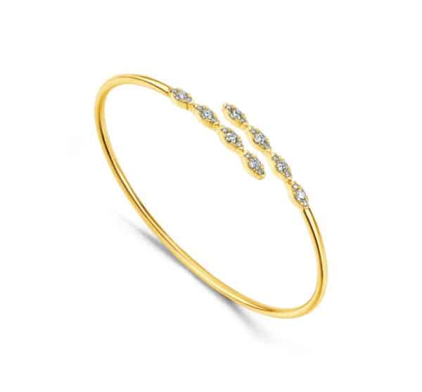 A yellow gold bangle with diamonds.