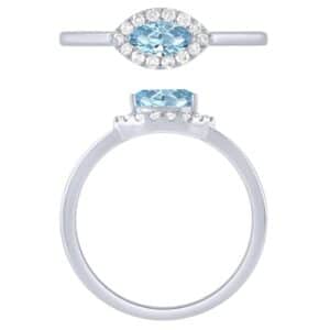 A white gold ring with a blue topaz and diamonds.