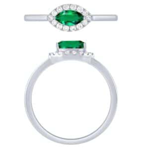 An emerald and diamond ring set in white gold.