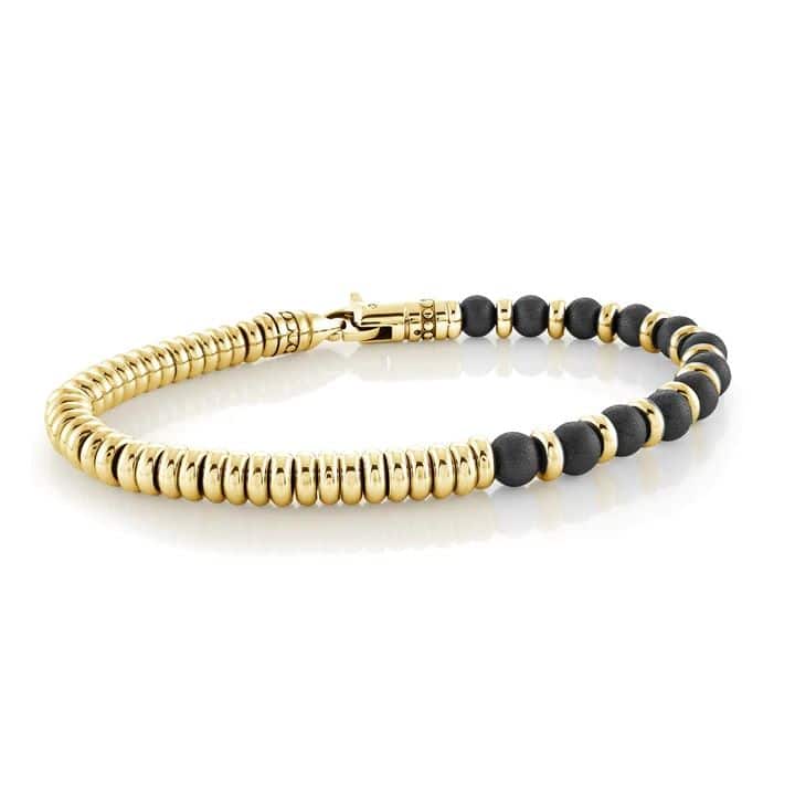 A gold bracelet with black onyx beads.