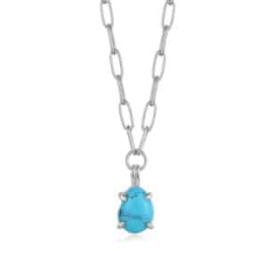 A necklace with a turquoise stone on a silver chain.