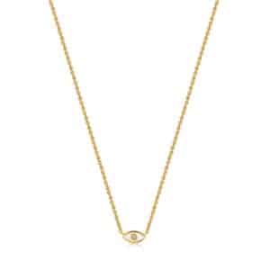 A gold necklace with an evil eye on it.