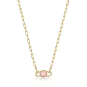 A necklace with a pink stone on a gold chain.