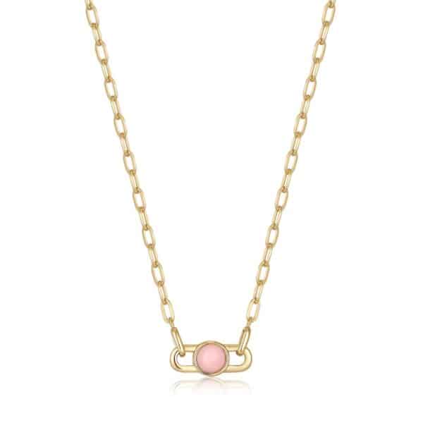 A necklace with a pink stone on a gold chain.