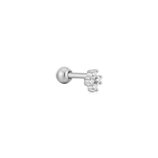 A silver stud ear piercing with a diamond in the center.