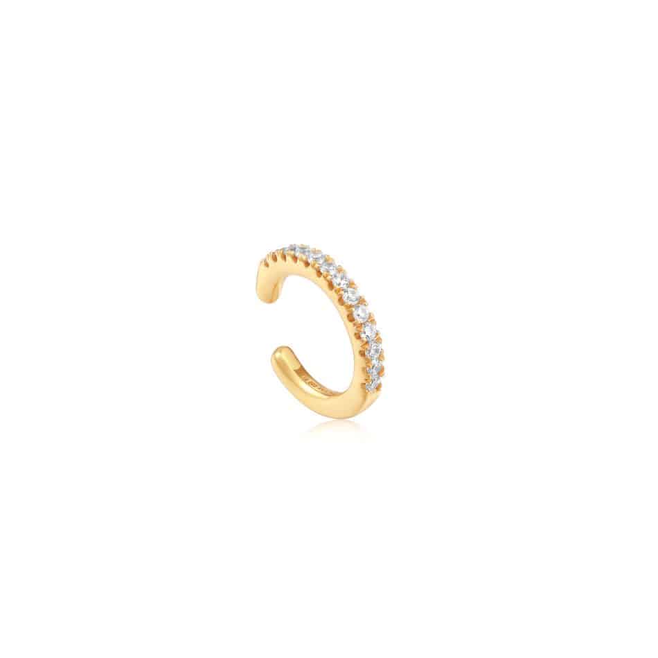A gold plated ear cuff with diamonds.
