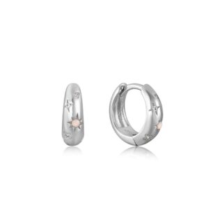 A pair of silver hoop earrings with pink diamonds.