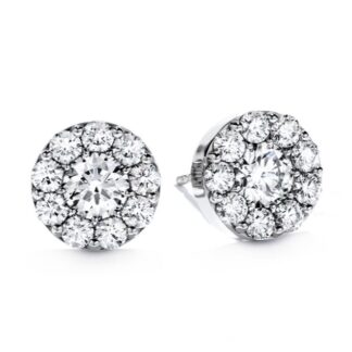 A pair of diamond halo stud earrings in white gold.