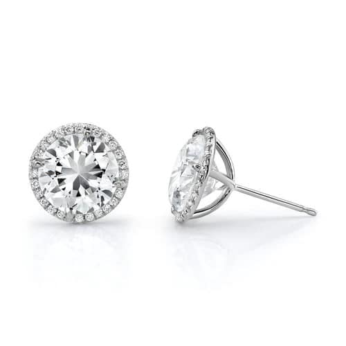 A pair of white gold halo stud earrings.