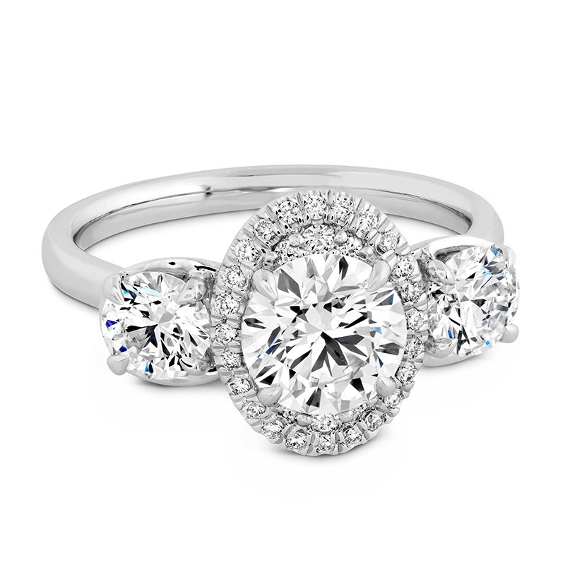 A white gold engagement ring with a halo and two diamonds.