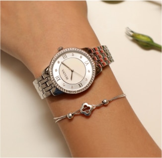 A woman's wrist with a silver watch and bracelet.