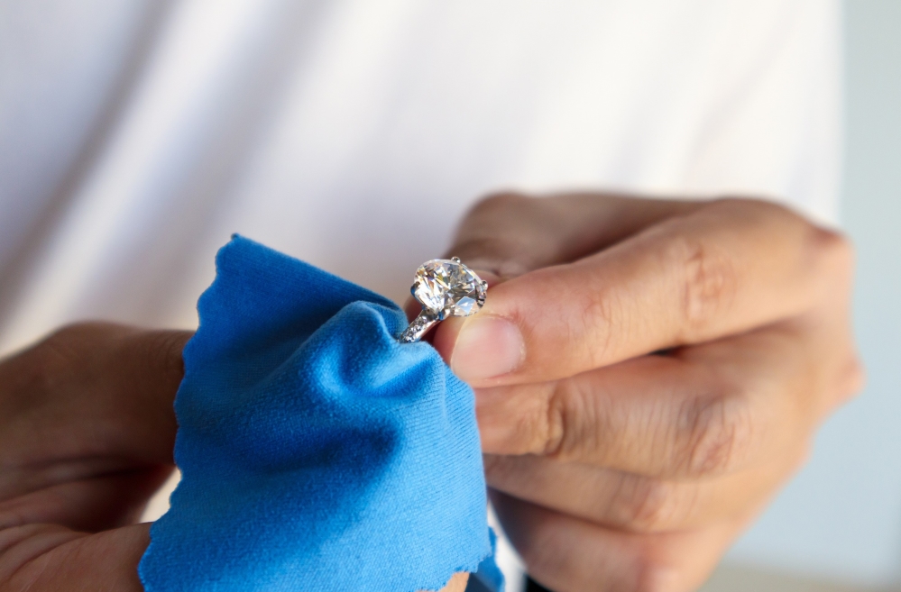 Person cleaning fine jewelry.